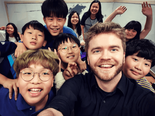 Milo with students in a classroom in Seoul